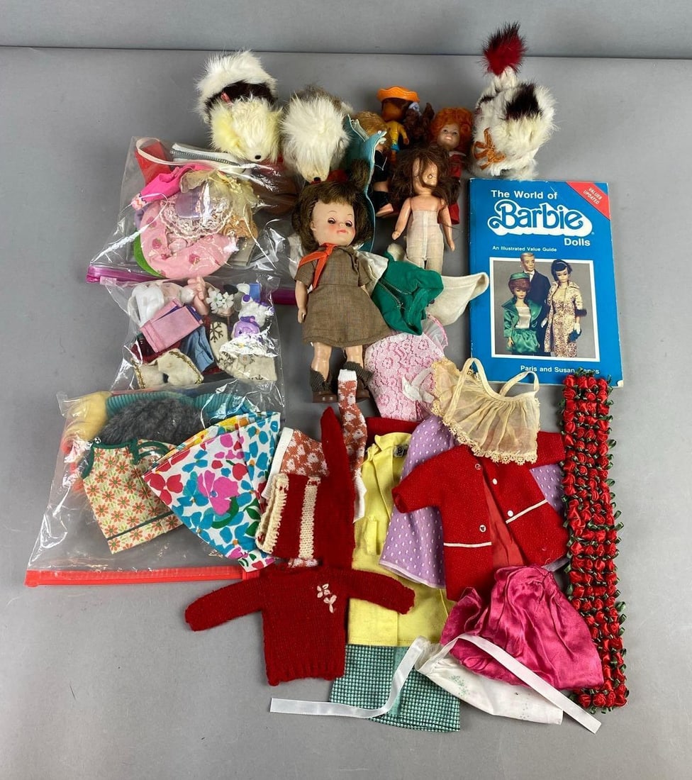 Group of Assorted Dolls and Accessories: Includes Clothing, Wind up Japanese Dogs, and more. Largest item measures L 8 1/2 x W 5 1/2 inches.