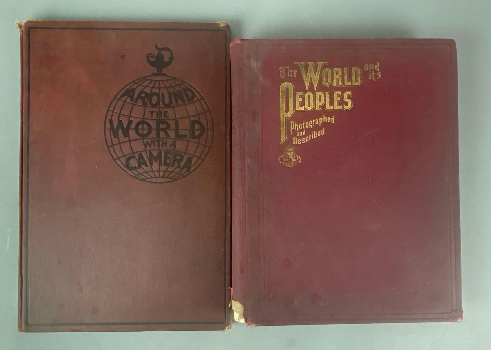 Group of 2 Antique Hardcover Books On The World: Includes 1914 Around the World with a camera and 1906 The World and It’s Peoples, some separation of pages from spine in both books, largest measures 16 1/4” H x 11” W