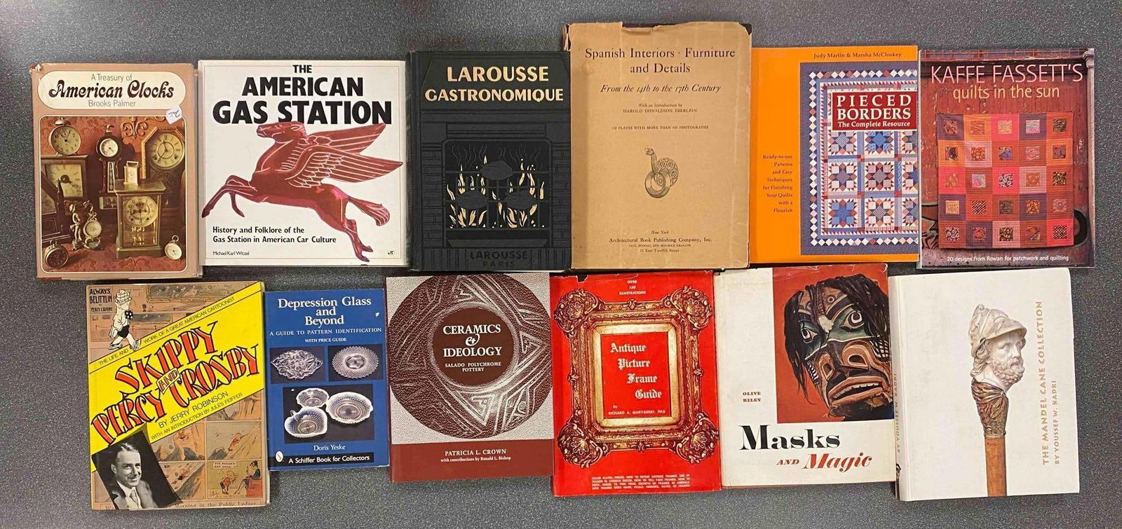 Group of 12 Assorted Books: Includes masks and magic, Depression glass, The American Gas Station and more, largest measures 12” H x 9 1/2” W