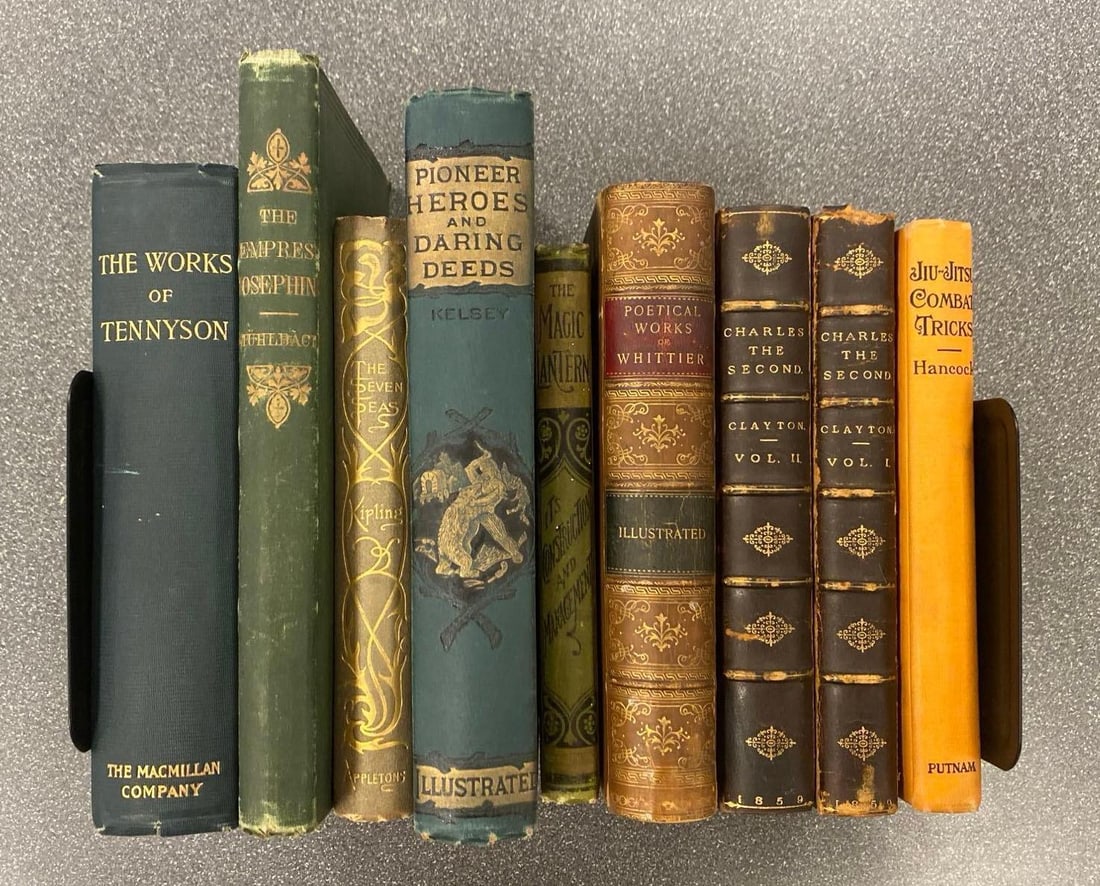 Group of 9 Antique Hardcover Books: Includes The Magic Lantern, Jiu-Jitsu Combat Tricks, The seven seas and more, largest measures 9” H x 6” W