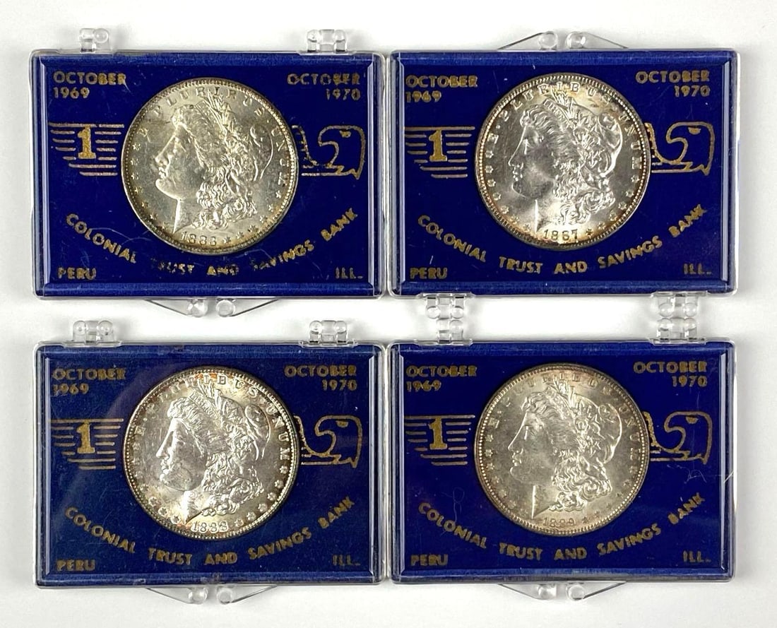 Group of 4 US Morgan Silver Dollars in Peru, Illinois 1st Anniversary Cases: Colonial Trust and Savings Bank. Morgan are years 1883 O, 1887,1888 and 1889.