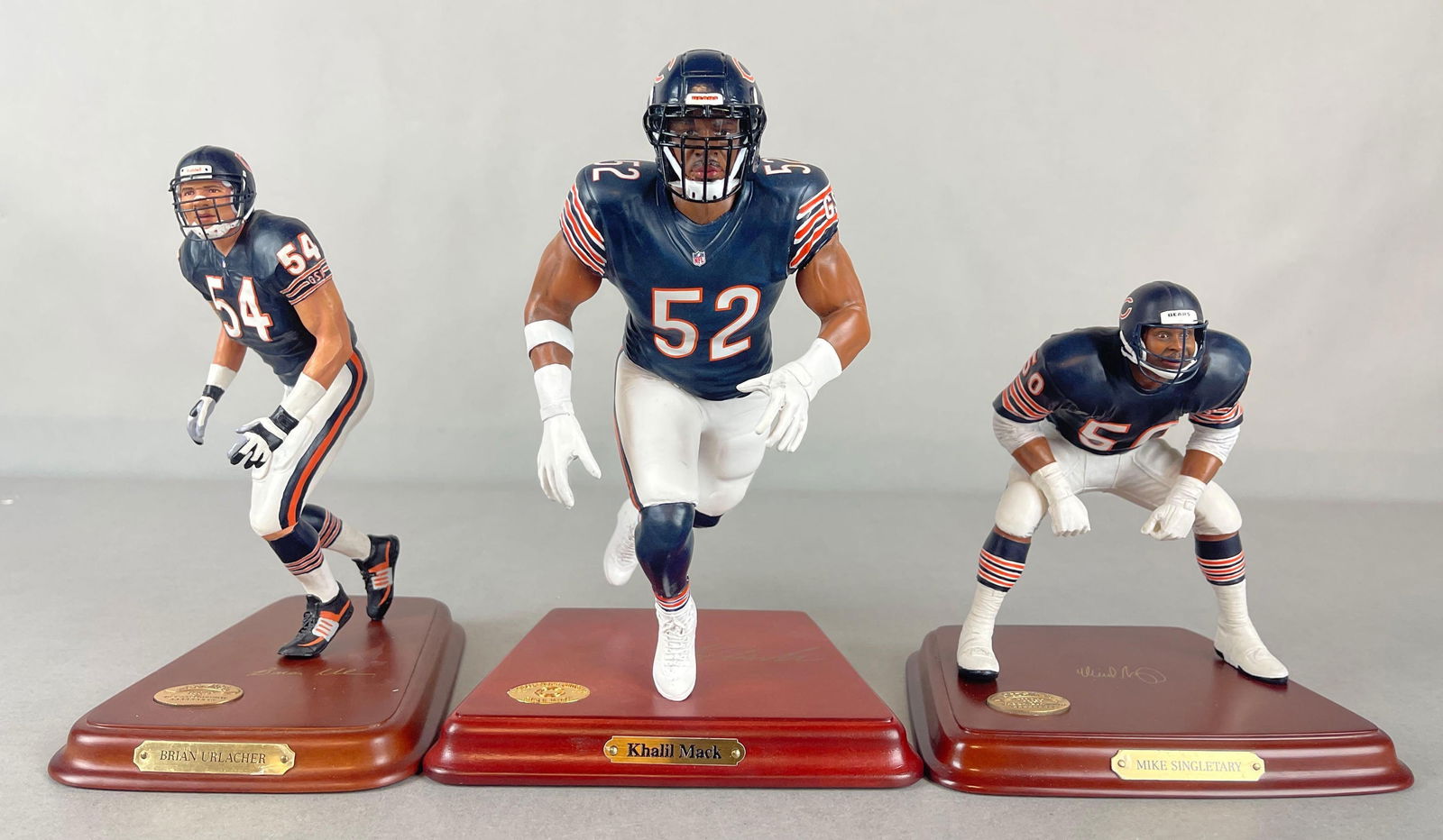 Khalil Mack, Brian Urlacher, and Mike Singletary Danbury Mint Figurine Statues: Khalil Mack #046, Brian Urlacher #E5528, and Mike Singletary, Largest measures 7 x 7 x 9 1/2 Inches