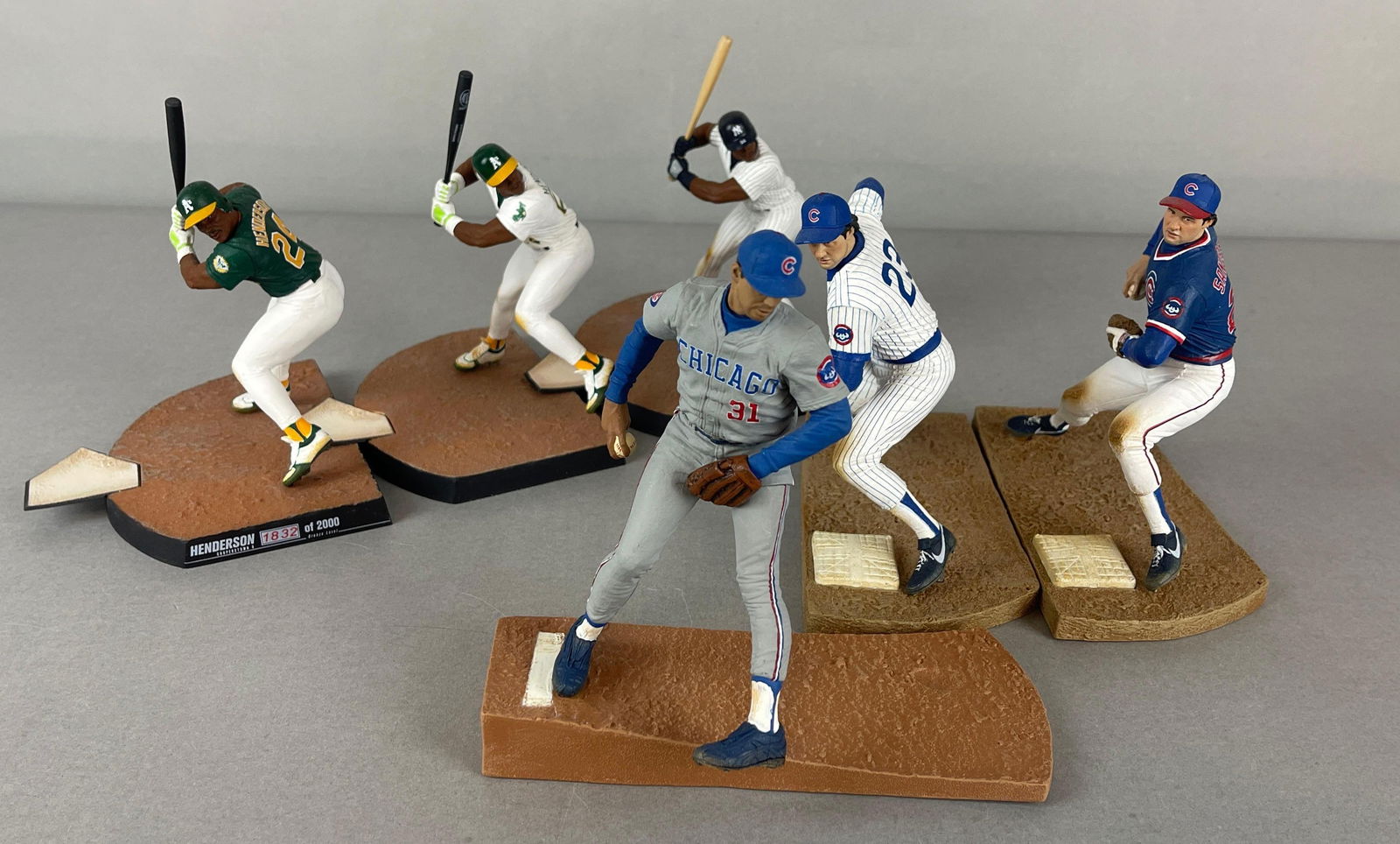 6 - Henderson, Sandberg, and Maddux McFarlane Figures: 2 - 2011 Rickey Henderson with Bronze level #1832/2000, Greg Maddux grey jersey, and Ryne Sandberg Home and Away jersey