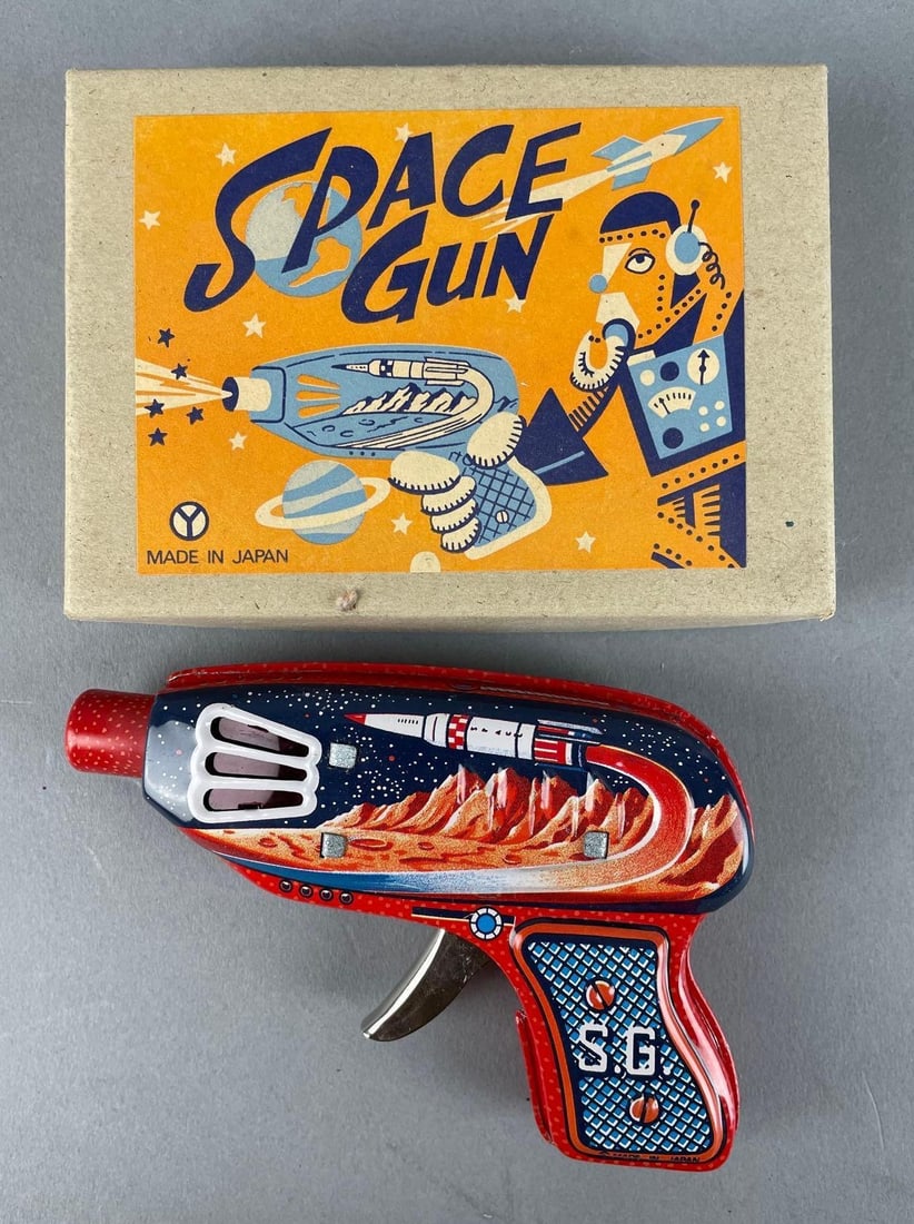 Yonezawa Japan Tin Litho Friction Space Ray Gun: Working condition sparks, original packaging measures 3 3/4" x 5 1/4" x 1 1/4"