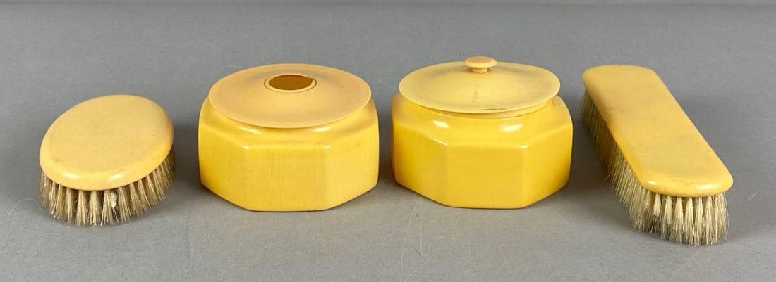 Yellow Celluloid Hair Receiver Vanity Set: Includes 2 brushes, hair jar and jar, largest brush measures 1 1/2” H x 7” W x 2” D