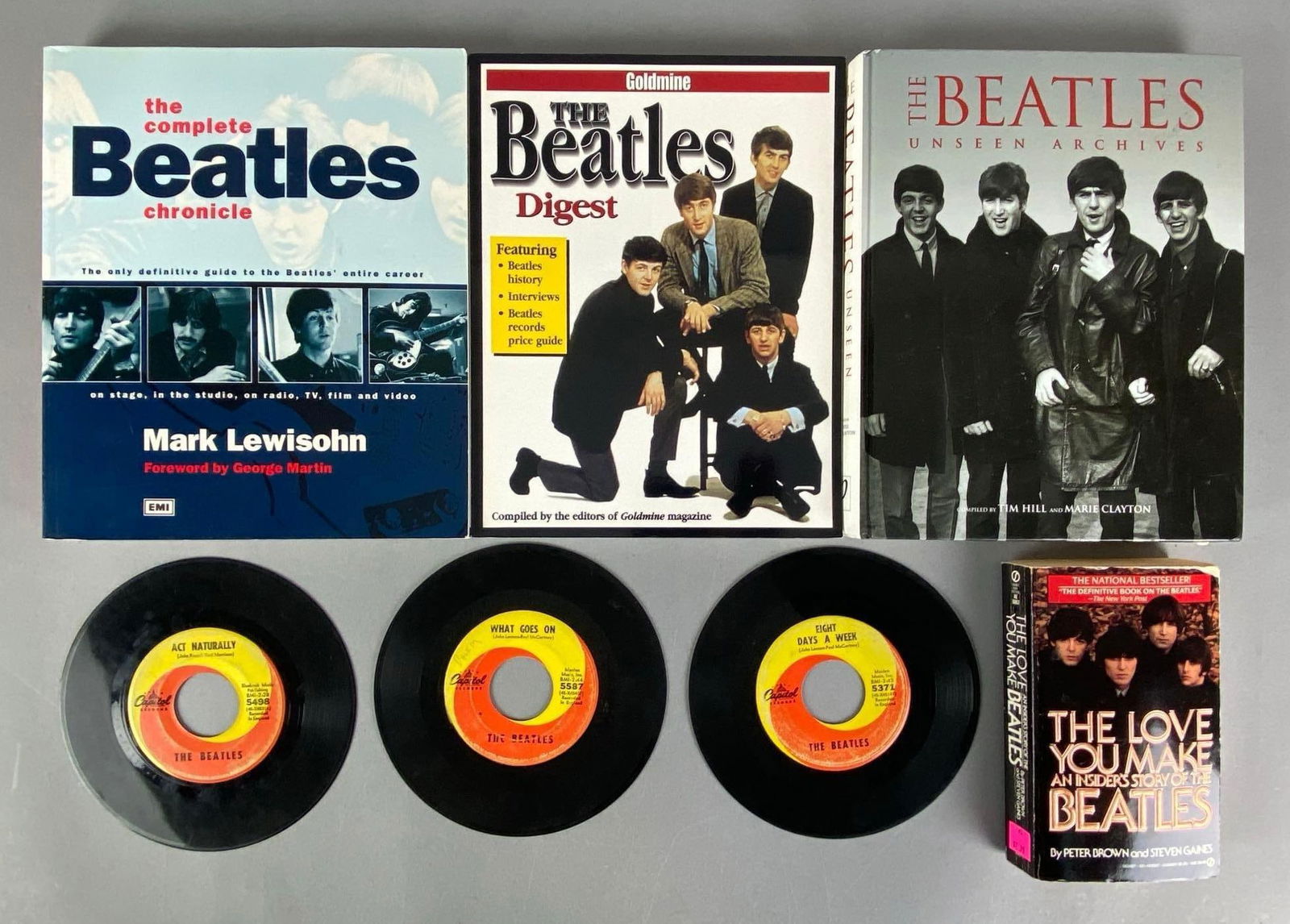 Group of The Beatles Books and Vinyl 45s: Includes the love you make, unseen archives, the Beatles digest and more