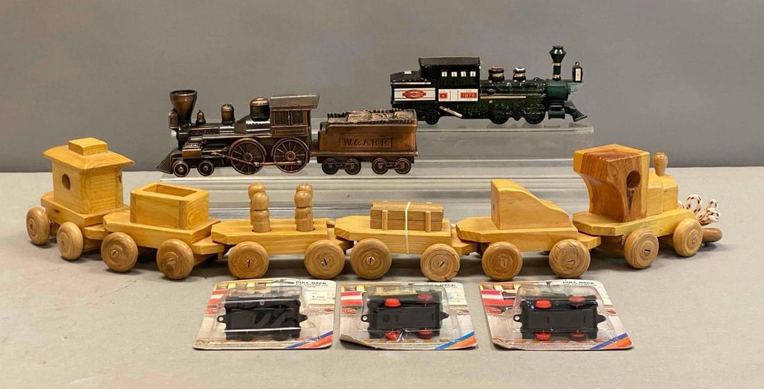 Group of Assorted Locomotive Themed Items: Includes wood pull along train, Avon Train perfume bottle, and more. Wood train measures 27” in length. Stand not included.
