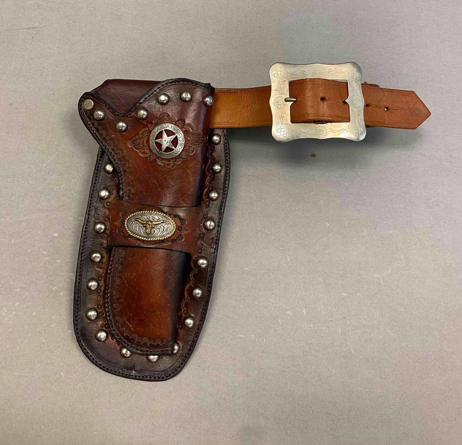 Vintage Child Cowboy Belt and Holster: Hand stitched leather with the lone star bag. Holster measures L 9 1/2 x W 4 1/2 inches.initials R.Bowers on back.