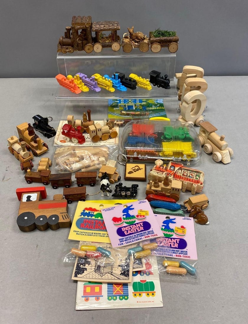 Group of Assorted Train Themed Toys and More: Includes Trains, Wood Trains, and Trains. Largest Train measures L 7 x W 4 inches. Stand not included.