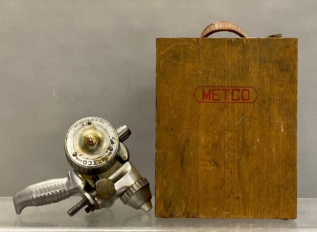 Vintage Metco Type 4E Metallizing Gun: Mfg in Westbury, N.Y. Box backing is missing l. Untested. Box measures H 11 x W 7 x L 9 inches.