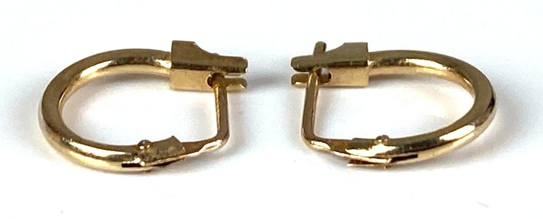 Pair of 14K Yellow Gold Hoop Earrings: Total weight of 0.3 grams, each measures 1/4” in diameter