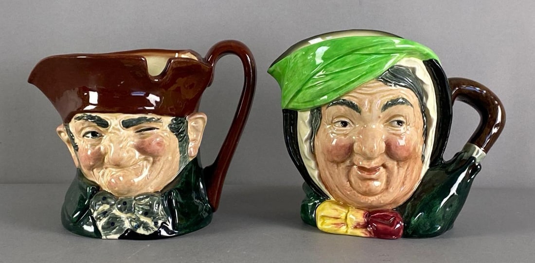 Group of 2 Vintage Royal Doulton Porcelain Character Mugs: Includes old Charley and sairey gamp, marked on base, largest measures 6” H x 7 1/2” W x 5 1/2” D
