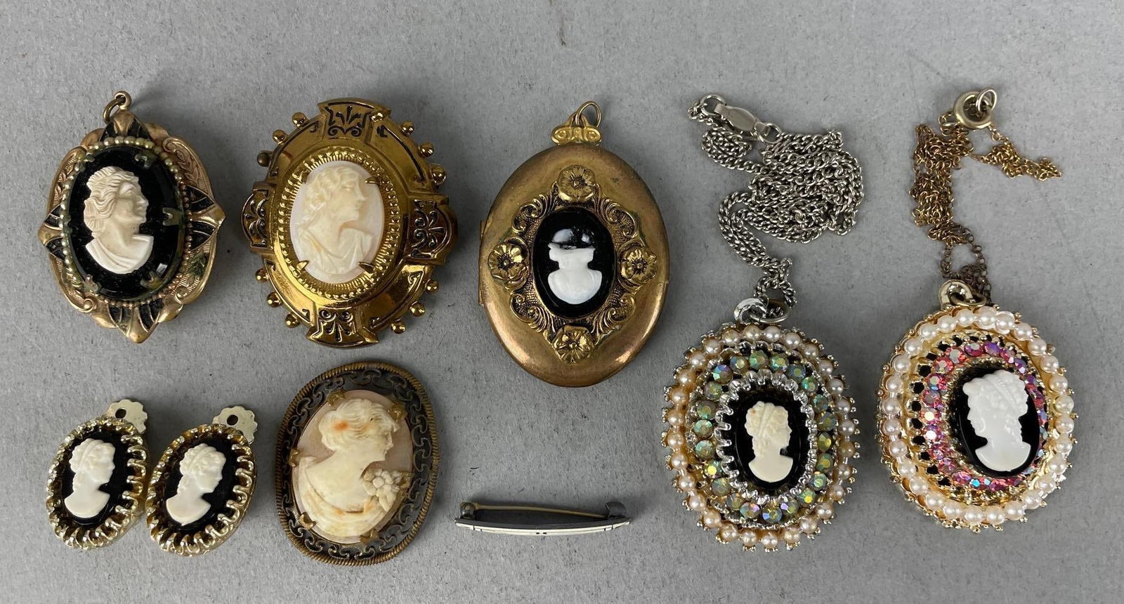 Group of Cameo Jewelry: Includes lockets, one with broken cameo, clip on earrings, pendants. Largest measures 1 3/4" x 1 1/2"