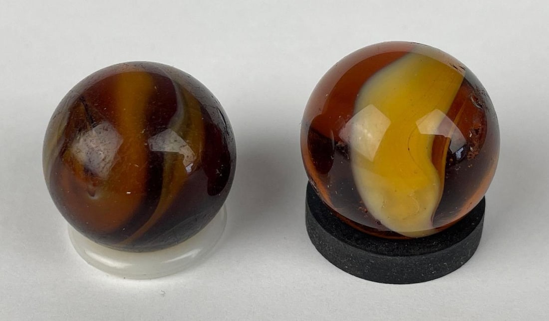 Group of 2 Vintage Brown Swirl Shooter Marbles: Akro agate style, some dings, largest measures 0.88 inches
