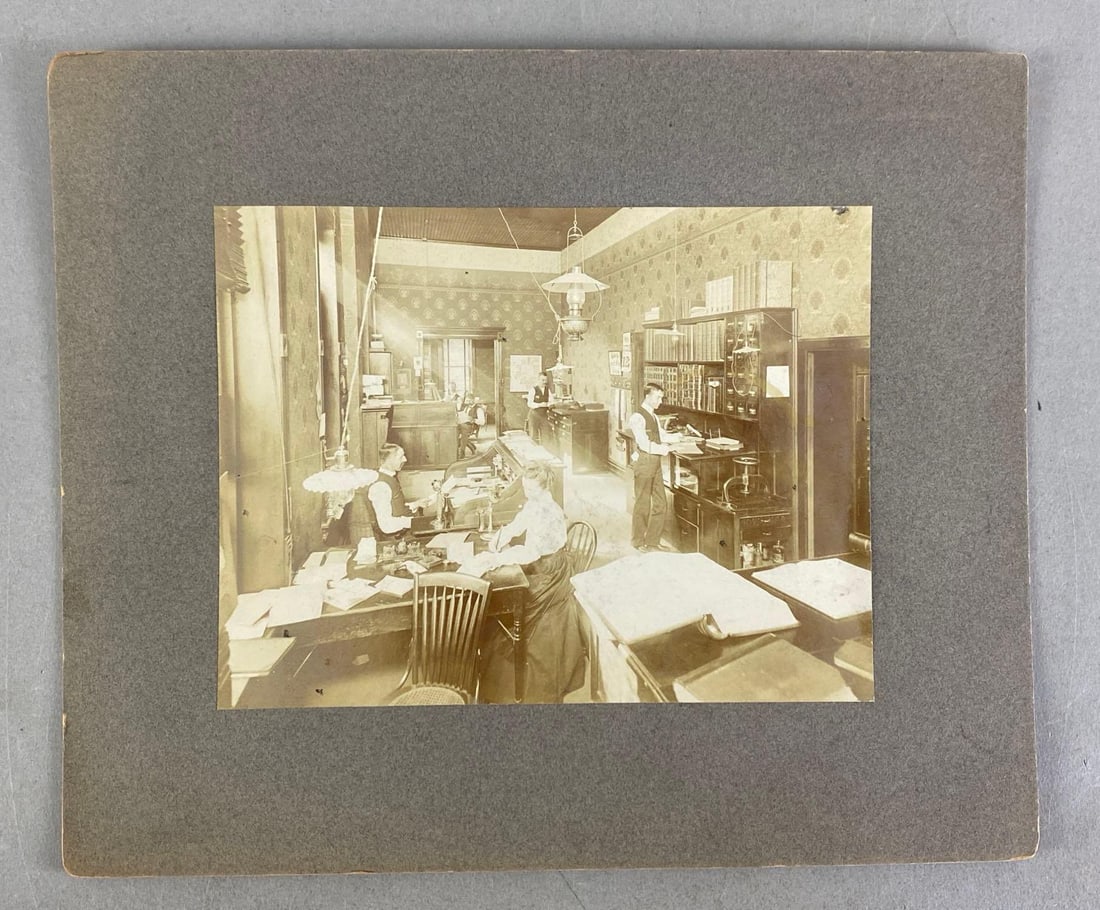 1890 Office of Sanders Bros Main Street Mounted Photograph: Features list of all people pictured on back, measures 10” H x 12” W