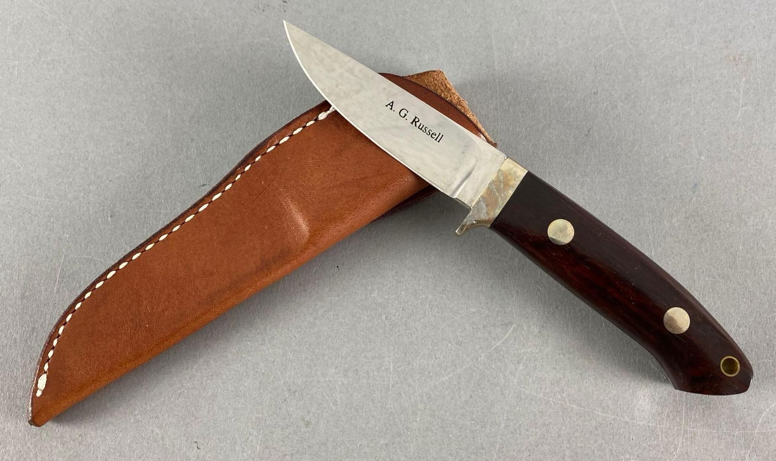 AG Russell Fixed Blade Knife with Leather Sheath: ATS-34 steel, made in Japan, measures 7” In length with a 3” blade