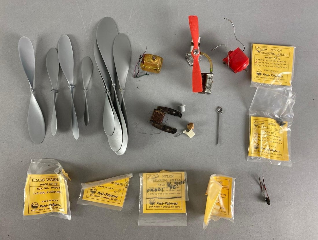 Group of Model Airplane Parts: Includes propellers, gaskets, wheel and more, largest piece measures 11” in length