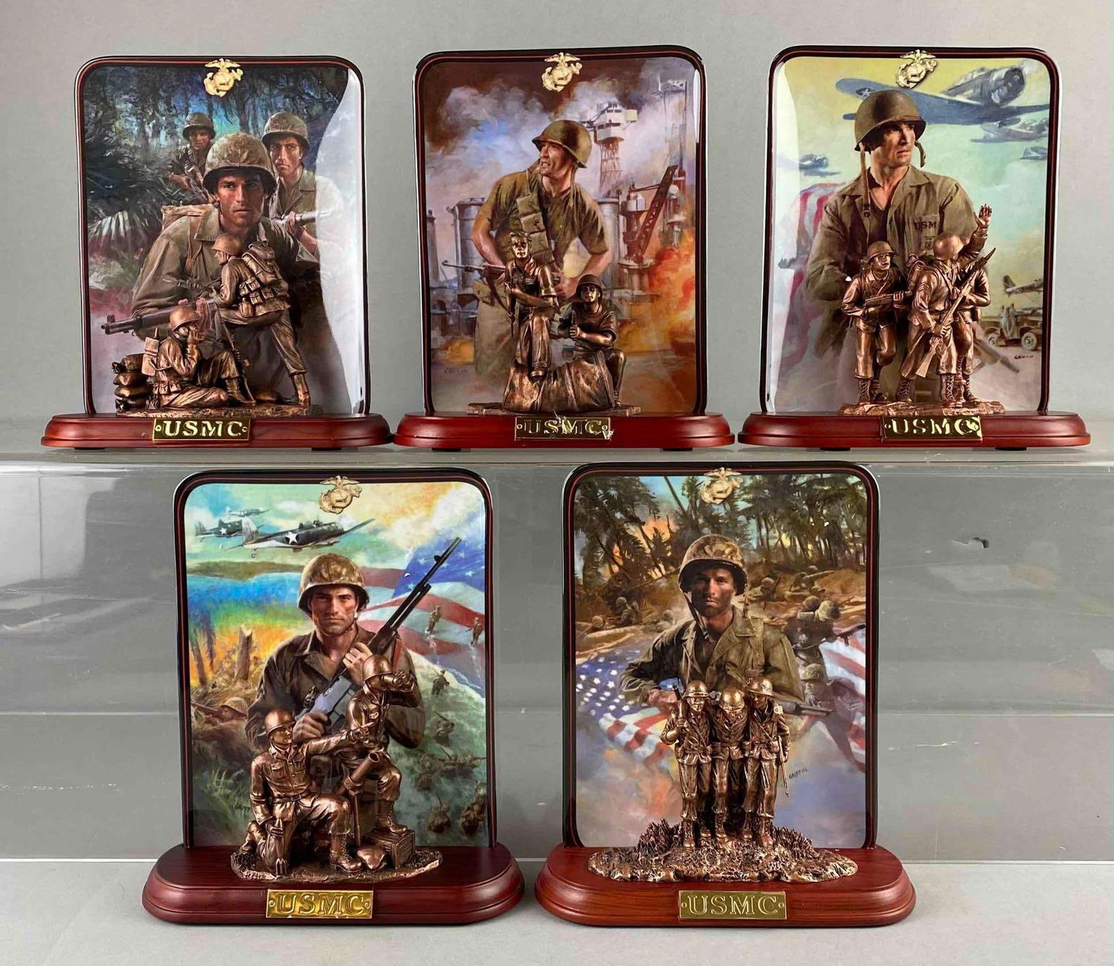 Group of 5 2001 The Bradford Exchange USMC Commemorative Plates: Includes Guadalcanal, Pearl Harbor, and more. One plate measures H 8 x W 2 1/2 x L 7 inches. Like new in original packaging. Stand not included.
