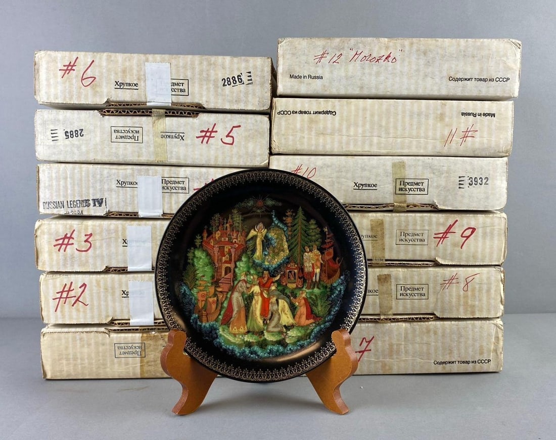 Group of 12 The Bradford Exchange Russian Legends Plates: Includes Mozoko, Czar Salton, and more. Like new in original packaging. One plate measures 7 1/2” in diameter. Stand not included.