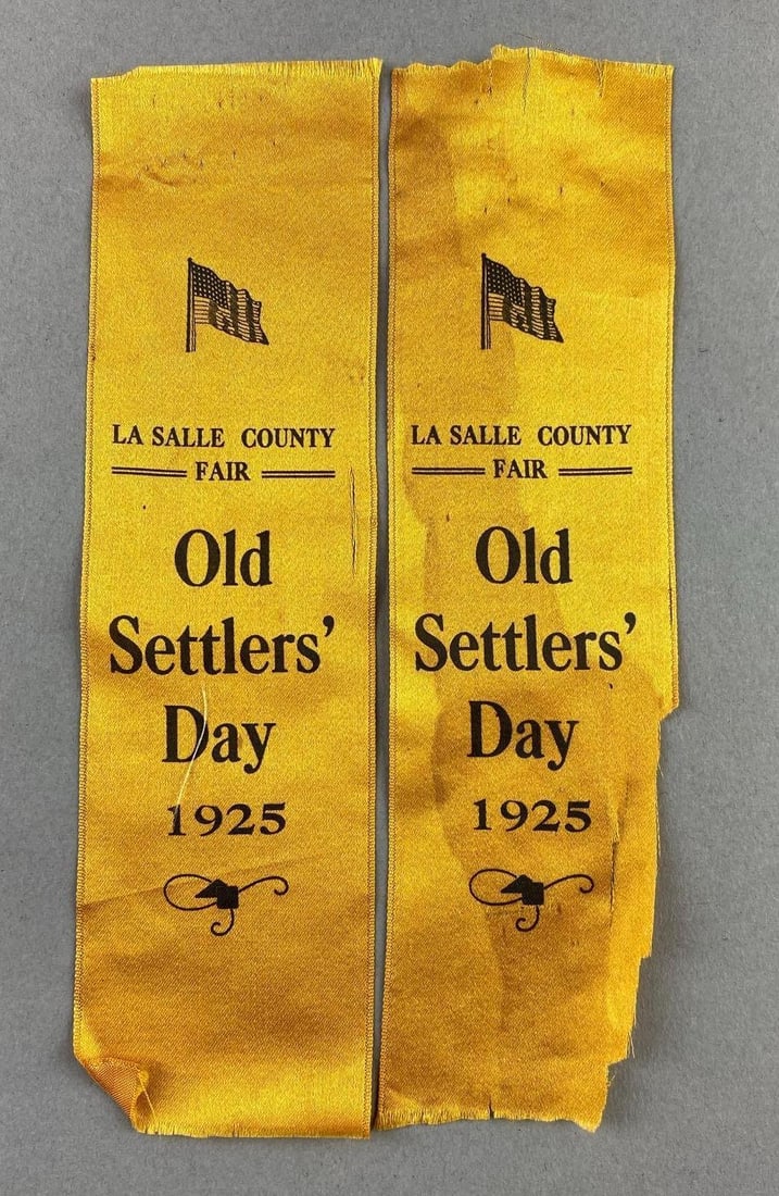 Group of 2 1925 La Salle County Fair Old Settlers Day Ribbons: One has rips and stains. Measures L 7 x W 2 inches.