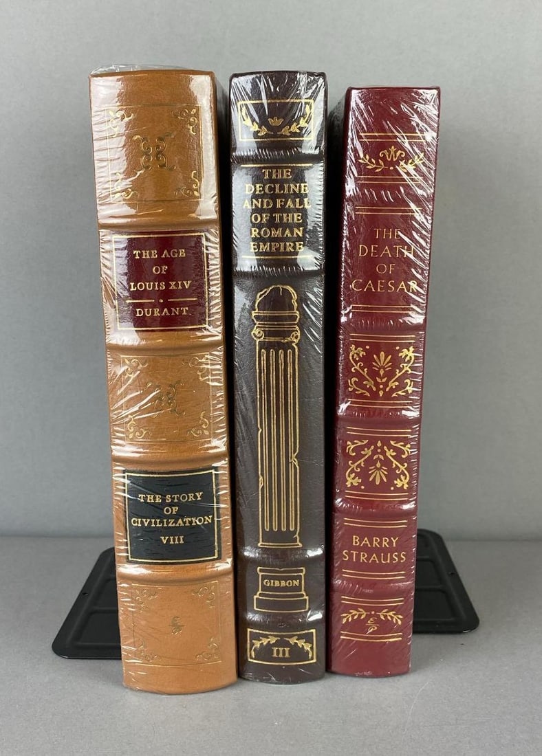 Group of 3 Easton Press Books: Includes The Death Of Caesar, The Decline and fall of the Roman Empire, and more. Sealed leather bound gilded spine. Largest measuresL 9 1/2 x W 7 inches.