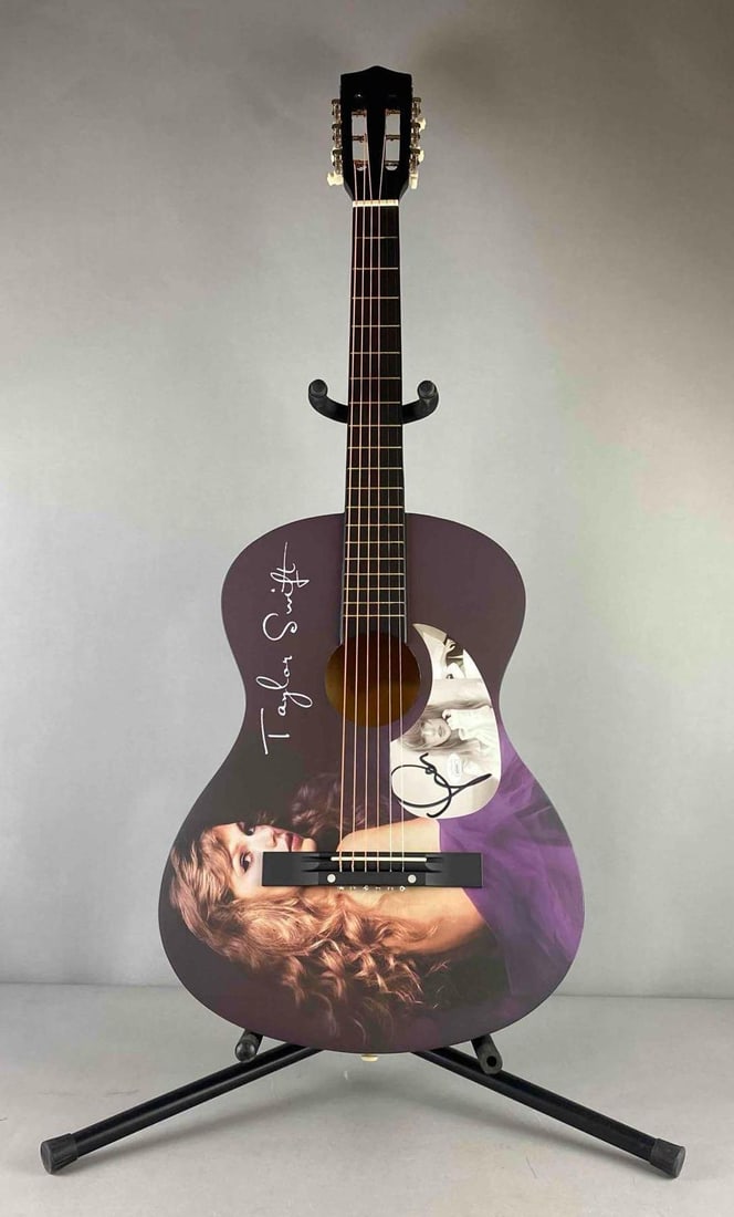 SIGNED Taylor Swift The Manuscript Acoustic Guitar: JSA AZ09990. Measures H 37 1/2 x W 3 1/2 x L 14 inches. Stand not included.