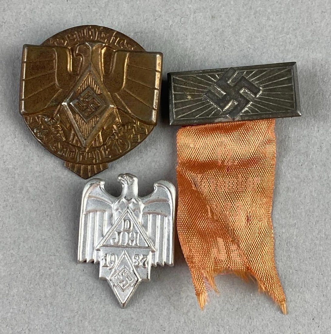 Group of 3 WW2 German Hitler Youth Event Badges: Includes 1936 Youth Badge, 1937 Youth Badge, and 1938 Youth Ribbon Badge. Largest measures L 1 1/2 x W 1 1/2 inches.