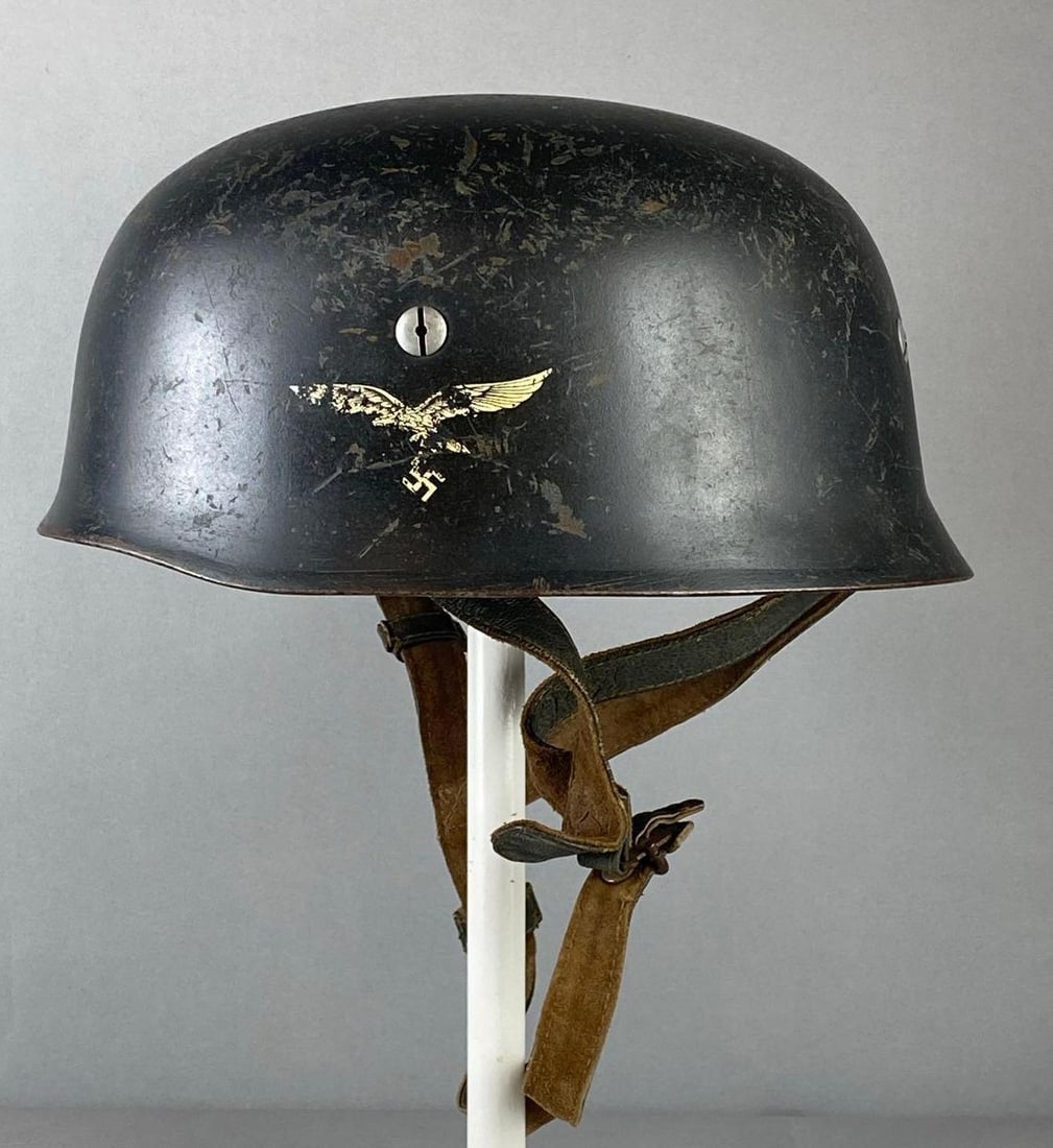 WW2 German M38 Fallschirmjager Paratrooper Stahlhelm Helmet: measure H 5 1/2 x W 9 x L 11 inches. Multiple scratches on outer side. Faded Luftwaffe Eagle. Helmet liner marked F.W. Muller Jr. stand not included.