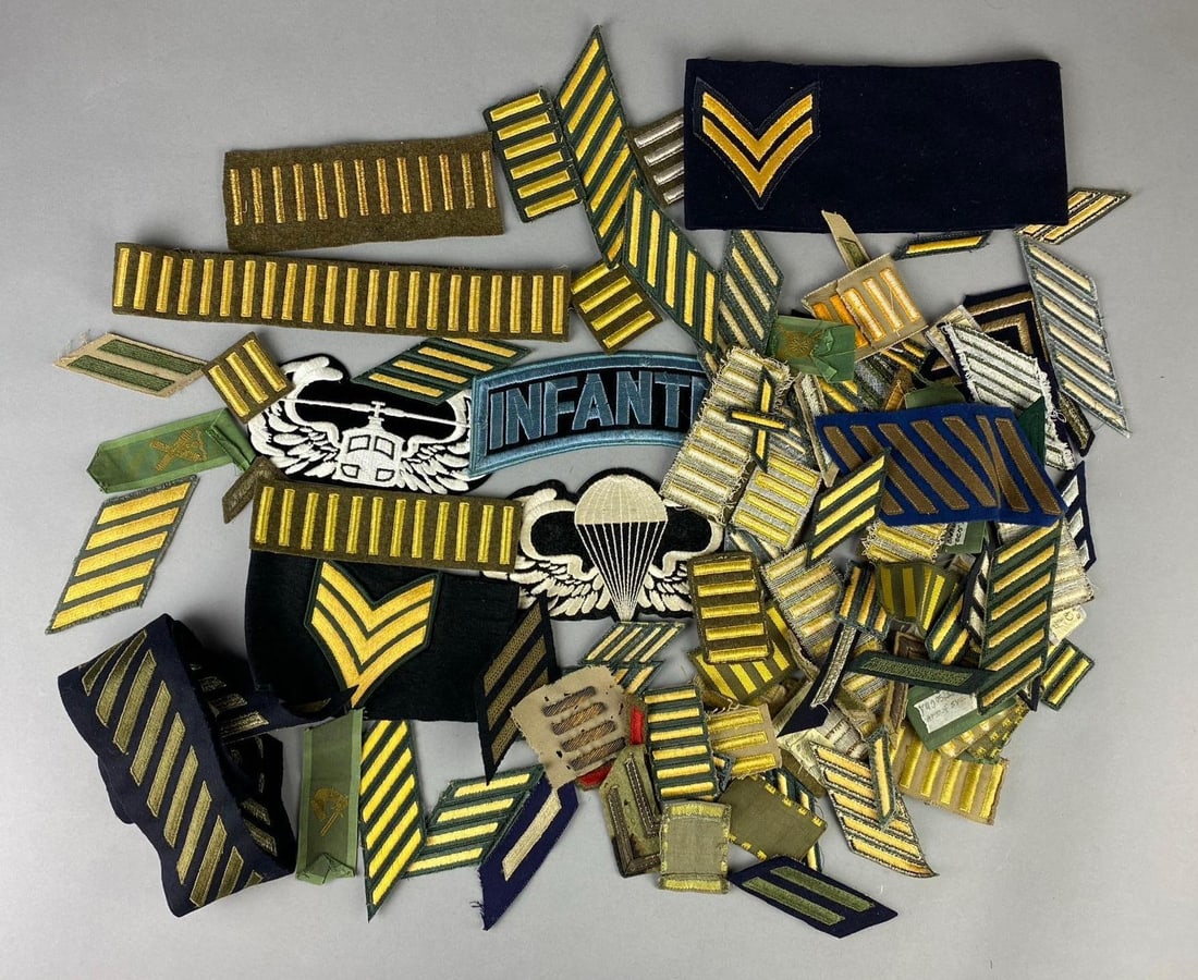 Group of 50+ WW2 US Military Insignia Patches and More: Includes WW2 Overseas Stripes, Service Stripes, and more. Largest measures 12” in length.