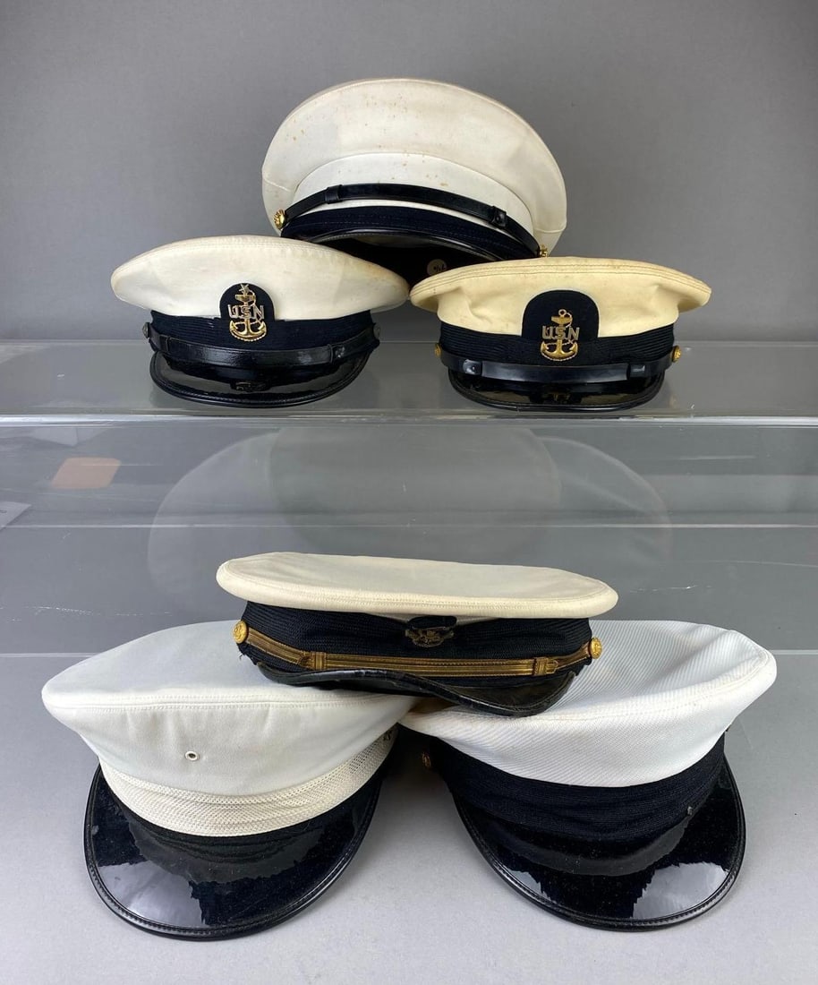 Group of Assorted US Navy Enlisted Visor Caps: Stand not included. Most Size 7 1/2”