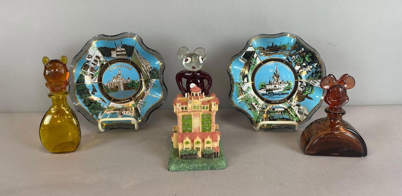 Group of Glass Walt Disney Items: Includes vintage Disneyland and Disneyland world souvenir bowls measuring 1 1/2" x 7 1/2"