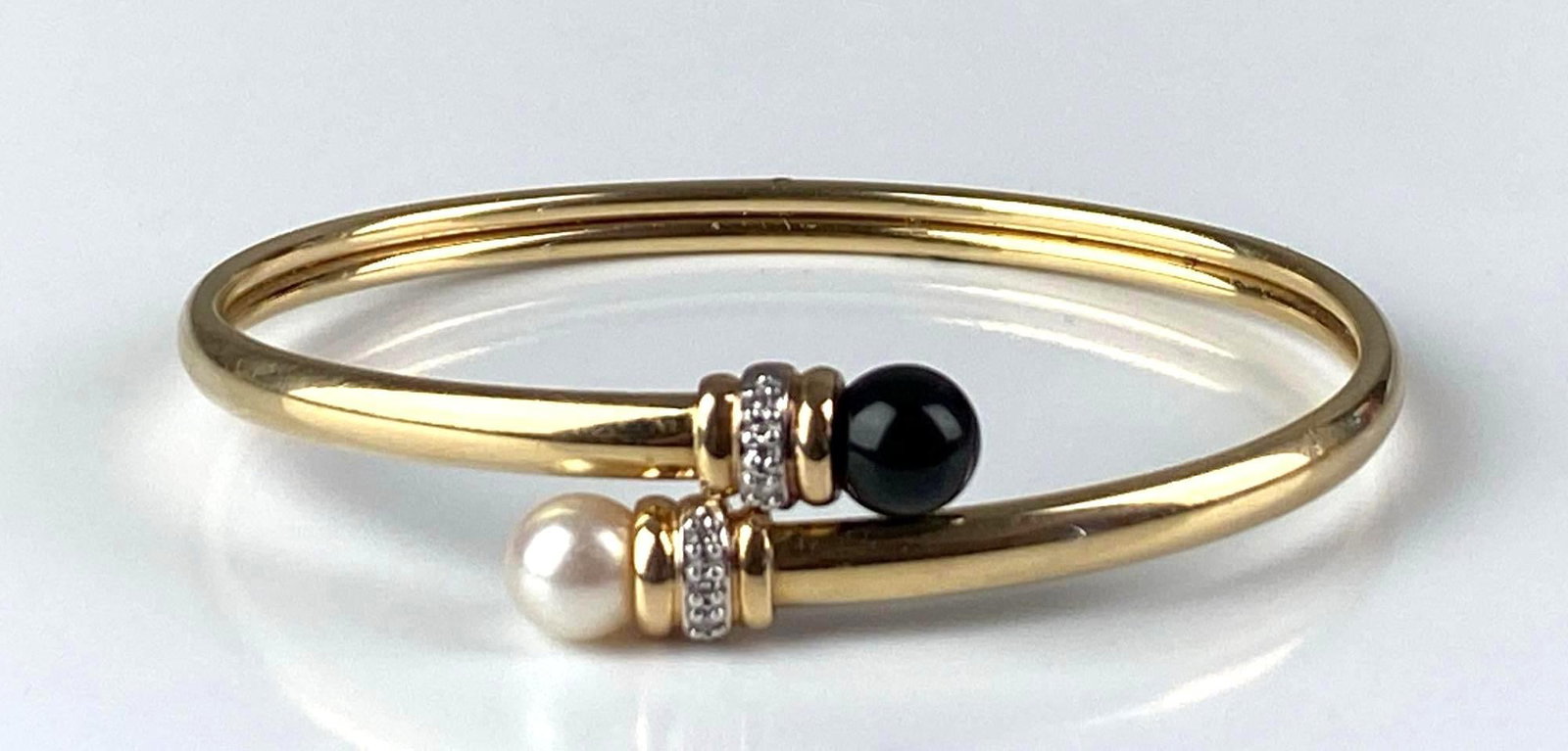 Signed 14K Yellow Gold Onyx Pearl Diamond Cuff Bracelet: Total weight of 7.9 grams, inner circumference measures 6 1/2
