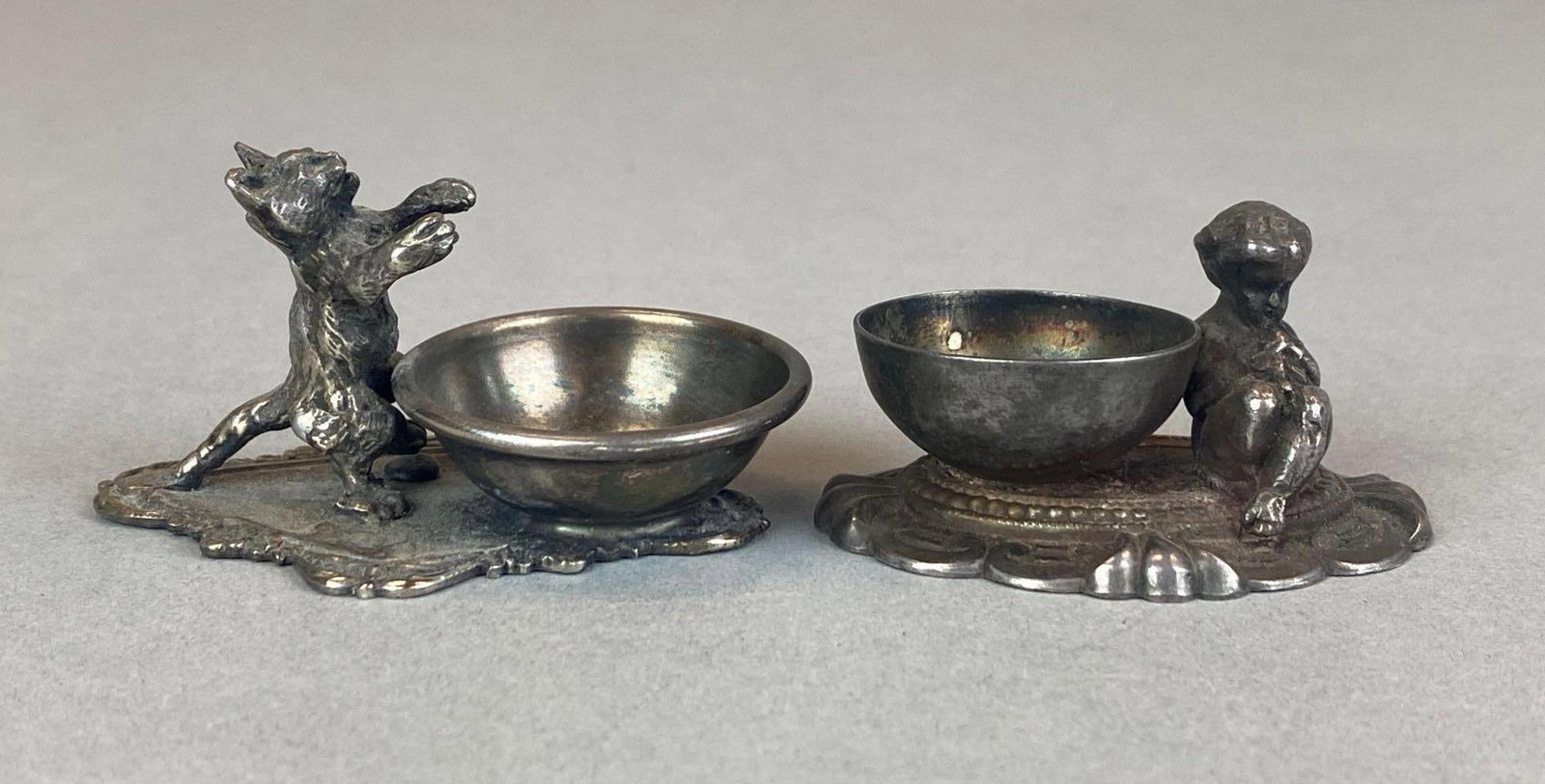 Group of 2 Antique Silver Plated Boy and Cat Figural Salts: Group of 2 Antique Silver Plated Boy and Cat Figural Salts largest measures 1 1/2? H x 2 1/2? W x 1 3/4? D