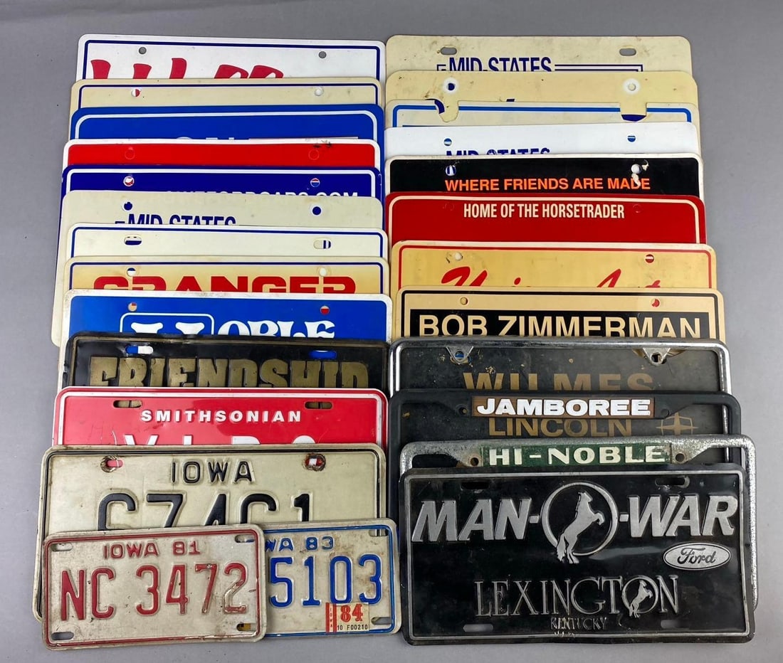 Group of Assorted Vintage Dealerships License plate Covers and More: Includes Ford Man O War, GM, and more. One measures L 12 x W 5 inches.