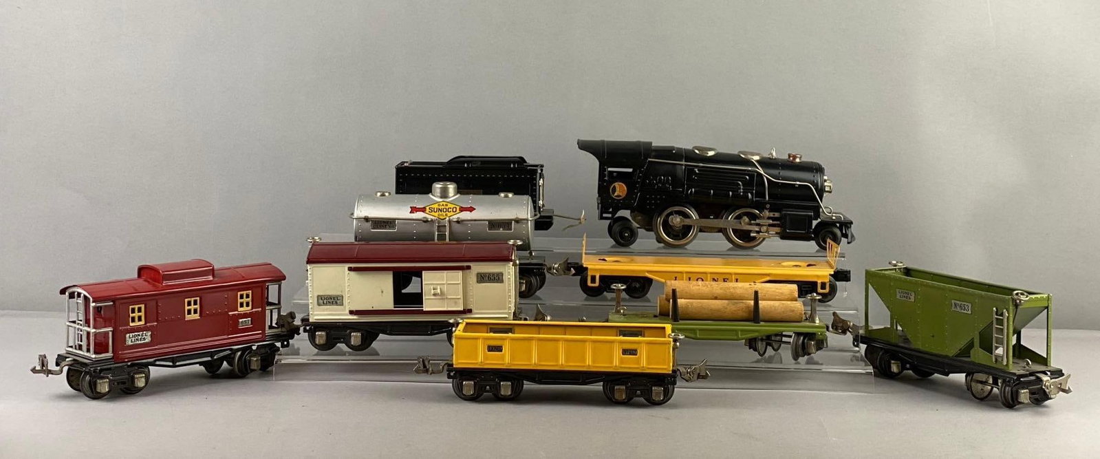 Group of 9 Vintage Lionel Trains O Gauge Locomotive and More: Includes Train cars, caboose, and more. Locomotive measures H 3 x W 2 x L 9 inches. Stand not included. Untested.