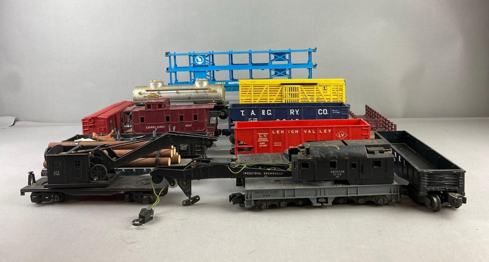 Group of Assorted Lionel Trains O Gauge Train Cars and More: Includes cranes, oil tanks, and more. Largest measures 13? in length. Stand not included.