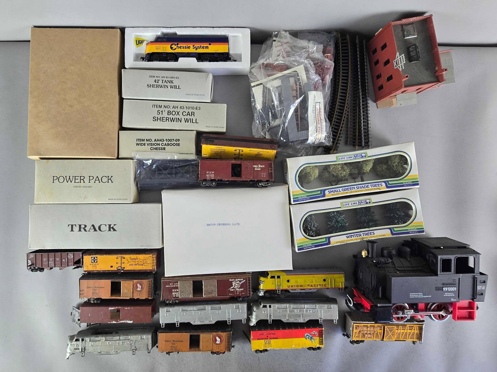 Group of HO Scale Model Train Cars and More: Untested, includes locomotives, trees, tracks and more, largest locomotive measures 10" in length