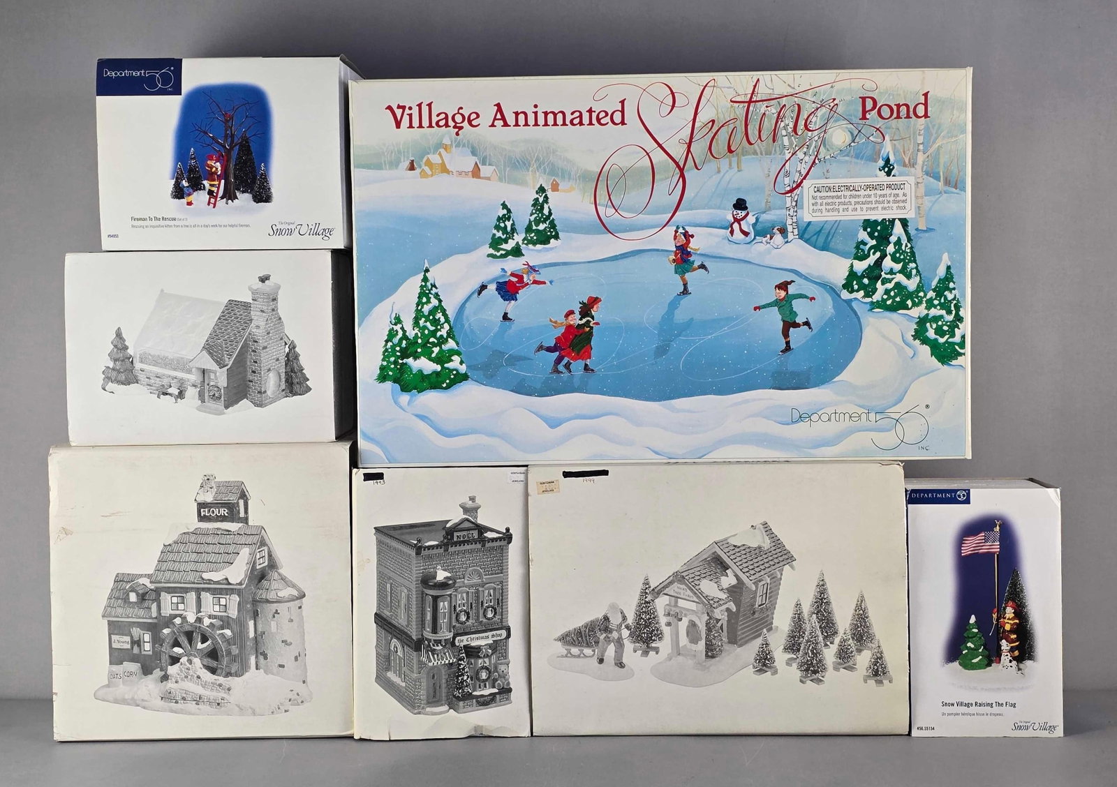 Group of Department 56 Snow Village Buildings and Accessoires: In original boxes, includes raising the flag, flour mill, animated skating pond and more, largest measures 14" H x 23" W x 3" D