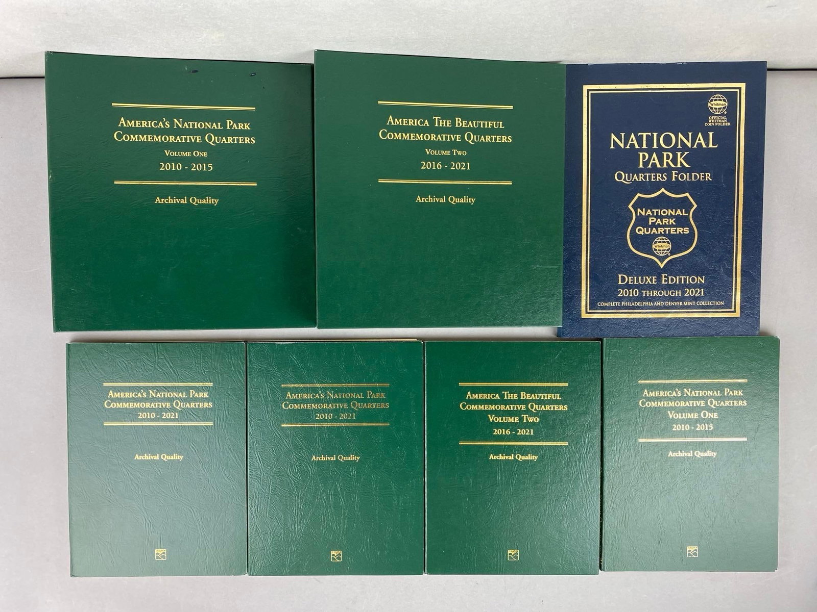 Group of 60 US Mint State Quarters in a Whitman Folder and More: Includes 6 empty Littleton Coin Folders.