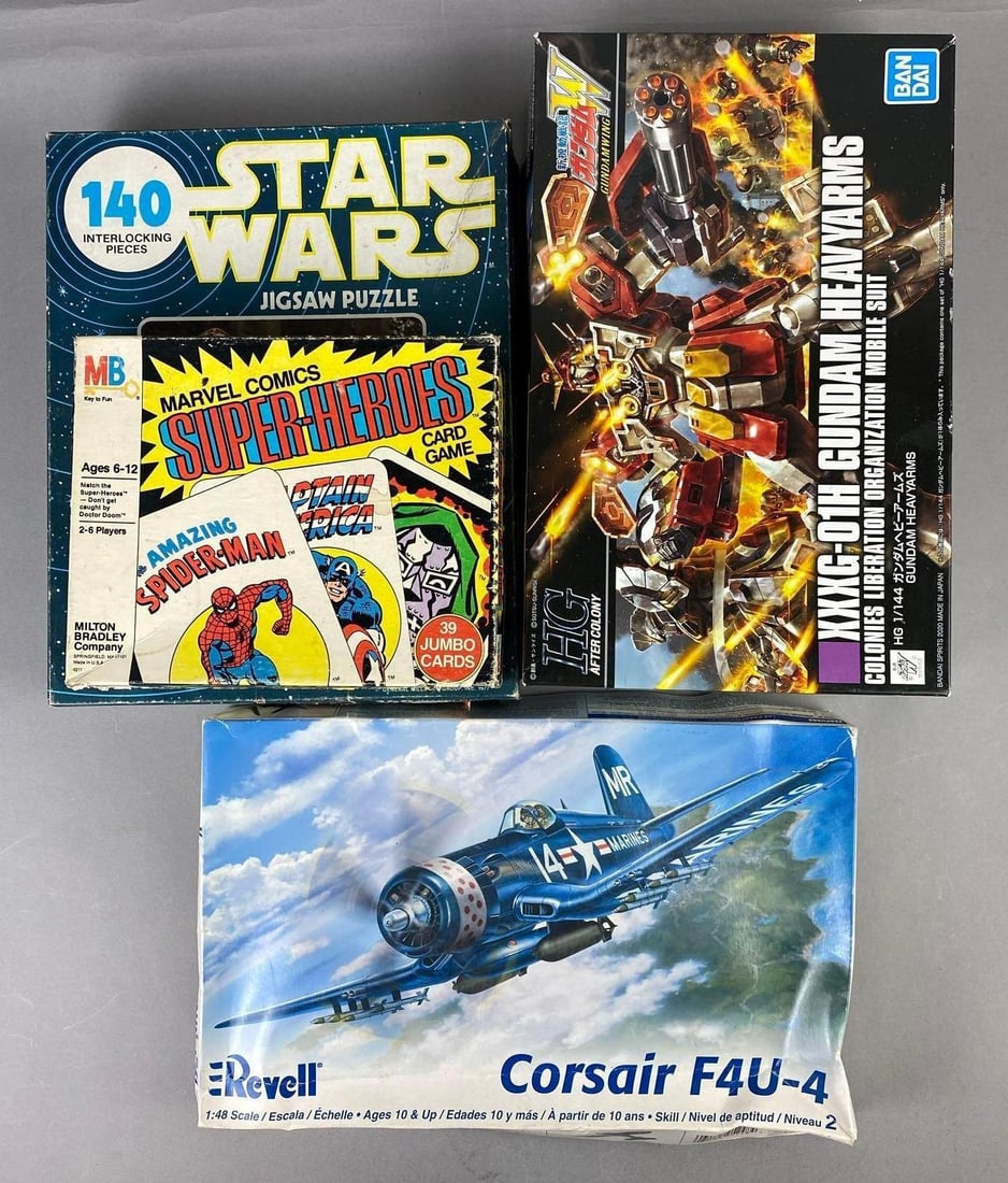 Group of 4 Assorted Games and More: Includes Revell 1:48 Scale Corsair, Gundam, and more. Largest measures H 2 1/2 x W 7 1/2 x L 12 inches.