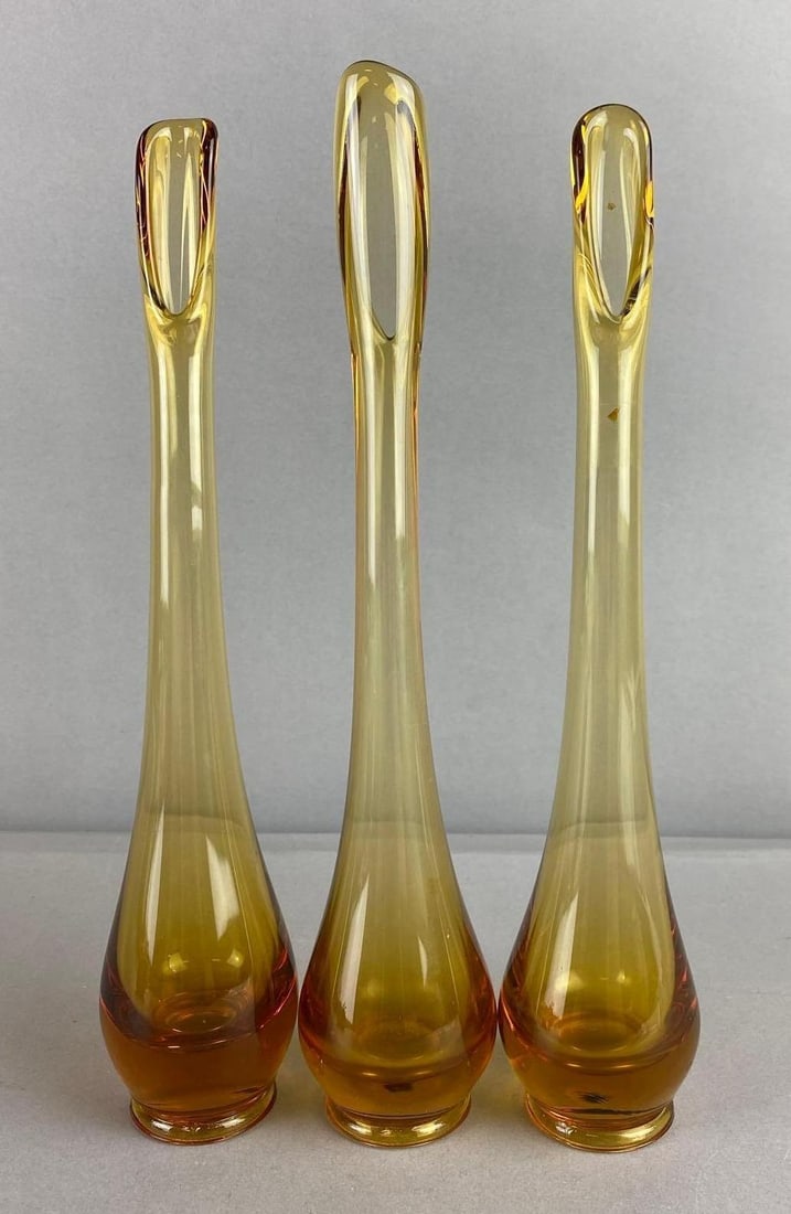 Group of 3 Vintage Viking Glass Epic Swung Bud Vases: Amber color. Largest measures 12 inches in length.