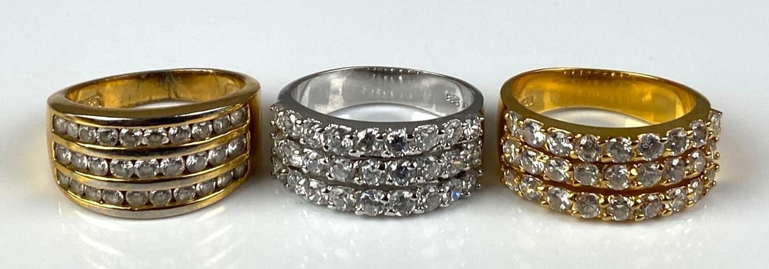Group of 3 Sterling Silver CZ Rings: 2 gold plated, sizes range from 9-9 1/2