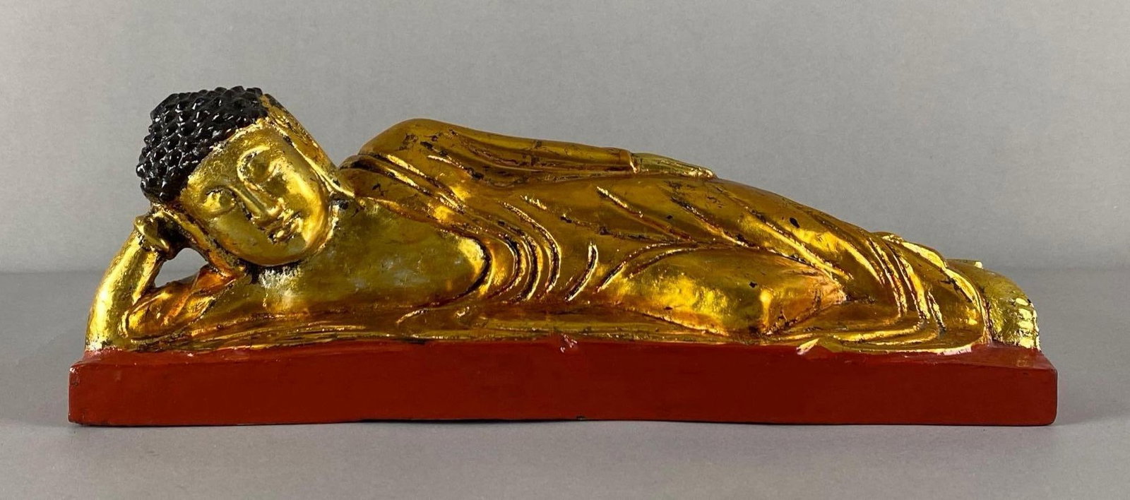 Gilded Reclining Buddha Wood Figurine: Measures 4 1/2 inches H x 12 1/2 inches W x 4 inches D