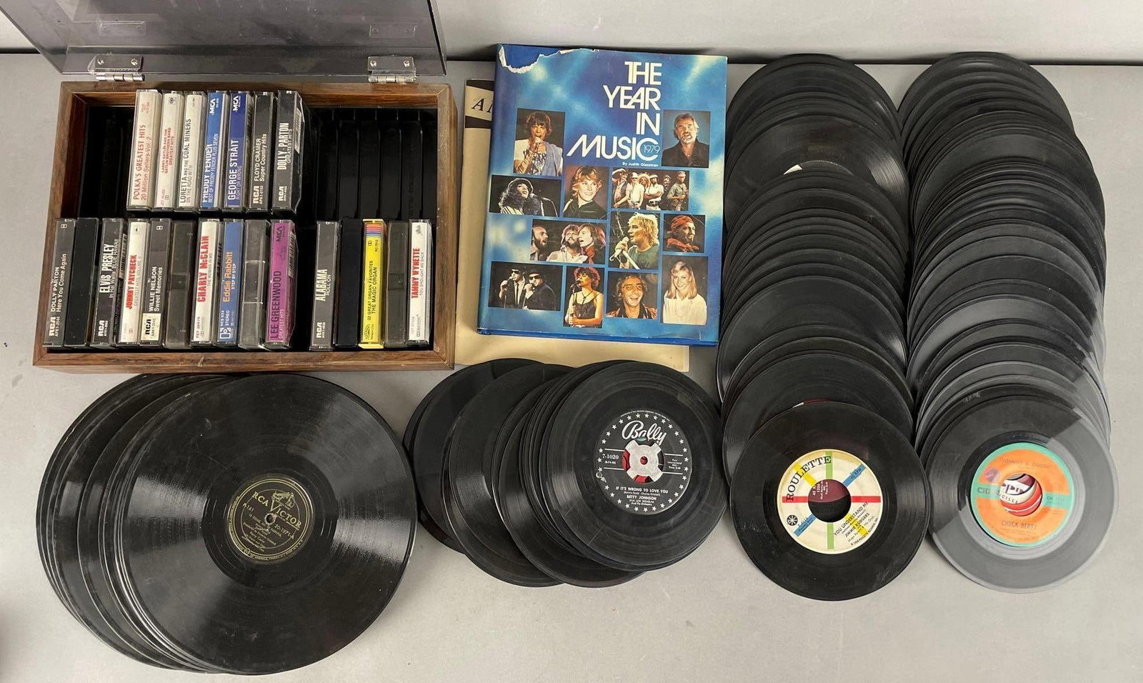 Group of 45 RPM Vinyl Records and More: Includes country cassette tapes, rca victor records, Elvis, Chuck berry
