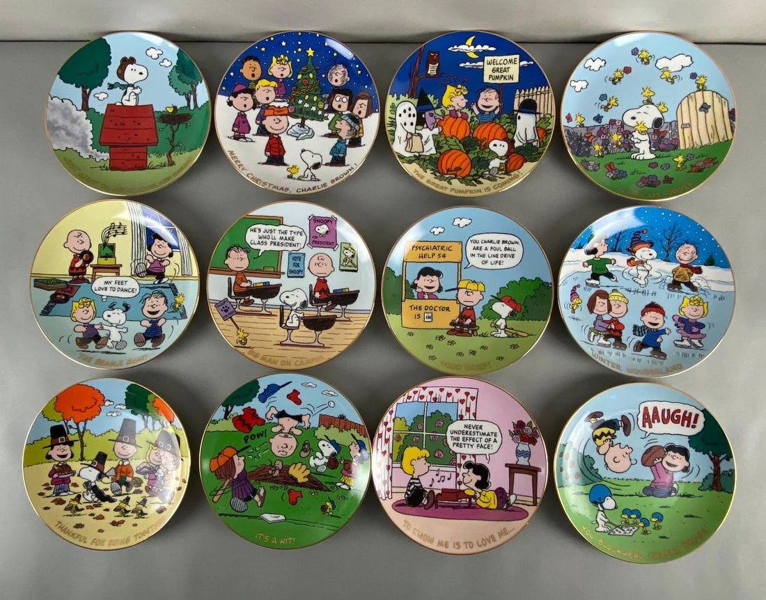 Group of 12 Danbury Mint Peanuts Magical Moments Collectors Plates: Limited Edition Collectors Plates, Includes Its a Hit, Winter Wonderland, Good Grief, and more, Includes 4 wall plate hangers, Plates measure 8 1/4 inches in diameter.