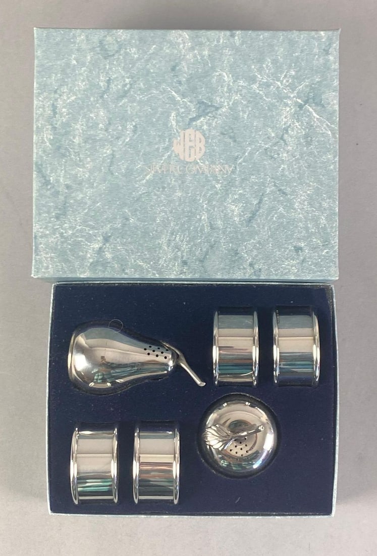 Set of Web Silver Co Pewter Tableware: Includes 4 napkin rings and fruit salt and pepper shakers, in original box, box measures 3 1/2 inches H x 7 inches W x 5 1/2@ D