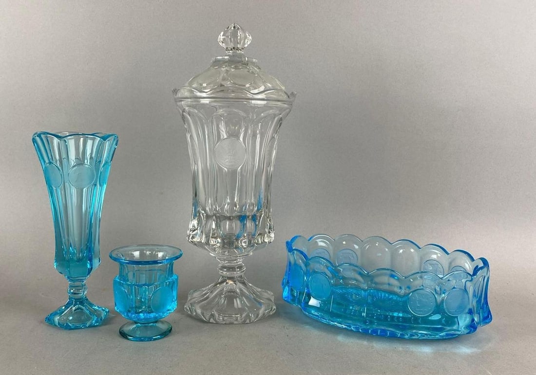 Group of 4 Fostoria Coin Items: Includes Footed Urn, Blue Oval Bowl, Cigarette Urn and more. Largest item measures H 13 x W 5 1/2 x D 5 1/2 inches.