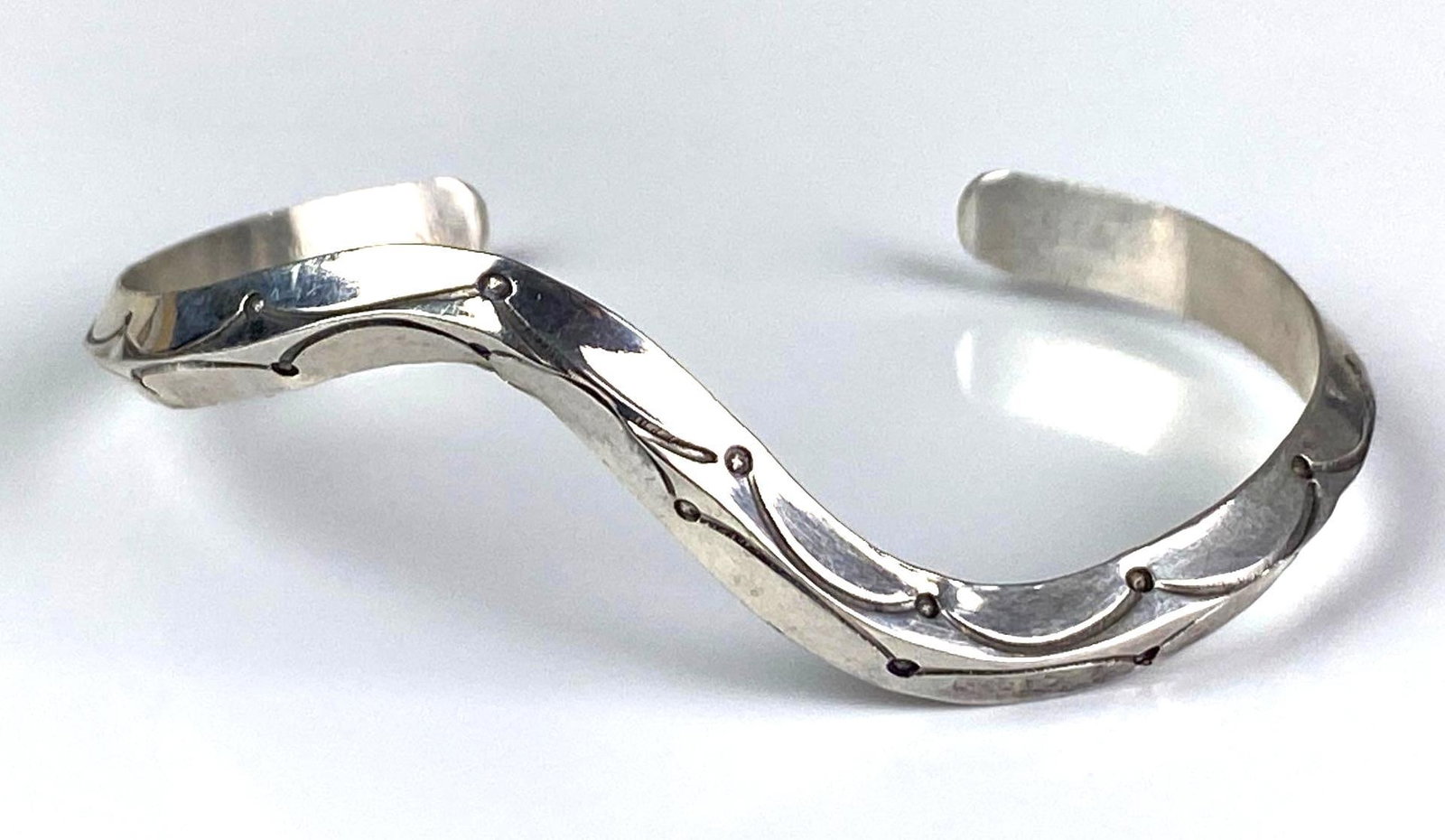 Signed JM Sterling Silver Cuff Bracelet: inner circumference measures 5 3/4 inches with a 1 inches opening
