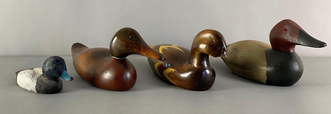 Group of 4 Wood Duck Decoys: 3 marked on base, one missing bill, largest measures 6 inches H x 5 inches W x 15 inches W
