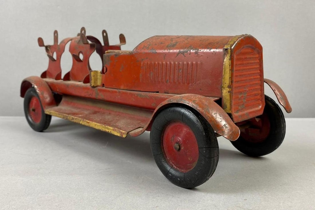 Antique 1920s Turners Toys Pressed Steel Fire Truck: Missing Ladders. Measures H 5 x W 5 1/2 x L 16 inches. Paint chips and rust throughout.